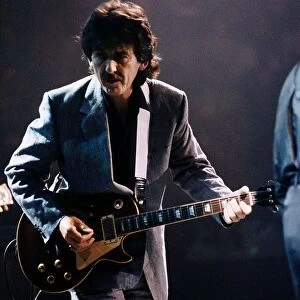 George Harrison on stage playing guitar October 1992