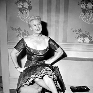 Ginger Rogers in the UK with her hands on her hips