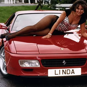 Glamour Mmodel Linda Lusardi sits on the bonnet of Ferrari 512TR. 2nd October 1993
