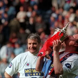 Glasgow Rangers footballer Paul Gascoigne kisses the trophy as he celebrates Rangers win