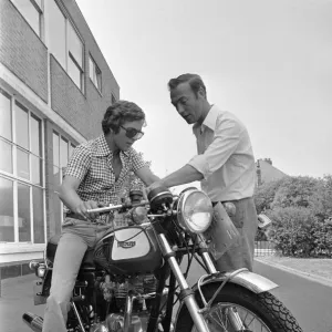 Grand Prix motorcycle road racer Phil Read sits on an Norton Villiers Triumph Bonneville