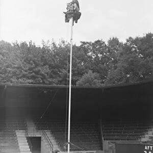 The Great Reno sitting on top of a 60 ft pole at Brighton Zoo after an arguement with his