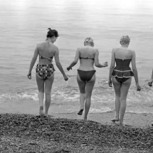 A group of women go for a swim on the beach at Brighton beach July 1958