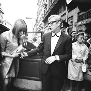 Harlow film premiere. Michael Caine arrives with Lucianna Paluzzi