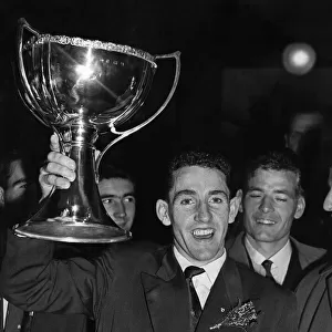 Hearts captain Dave Mackay proudly holds aloft the league cup. 25th October 1958