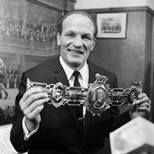 Henry Cooper, proudly shows off his 3rd Lonsdale bet, which was presented to him by Sir