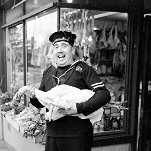 HM Submariner Bill Hayne enjoys collects the turkey for christmas dinner whilst on a