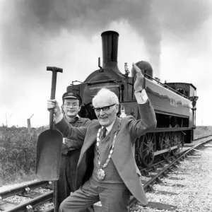 Holding a firemans shovel, the Mayor, Coun. Frank Mavin