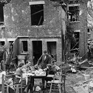 Their home destroyed by a German V-1 flying bomb, the Metcalf family carrying on with
