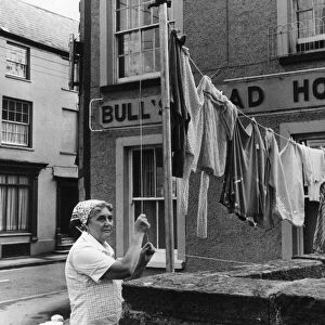 Hotel Landlady Mrs Maureen Roach puts up another line of washing outside the Bull