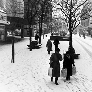 Huddled up against the winter snow, shoppers in a strangely quiet Church Street during