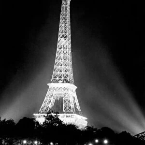 Image shot from across the River Seine showing the illuminated he Eiffel Tower