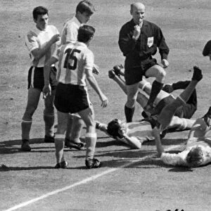 Jack Charlton (R) on ground about to be kicked by an Argentinian Player