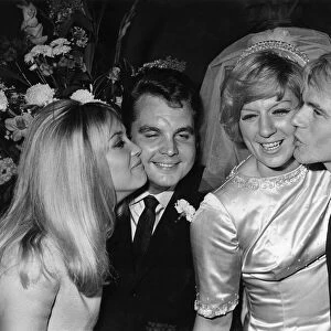Jackie Irving kisses Tony Hatch while Adam Faith kisses Jackie Trent after the wedding