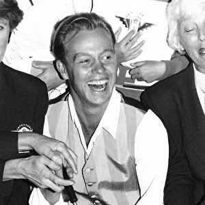 Jason Donovan actor and singer cuts a cake at Gatwick Airport to mark the 21st