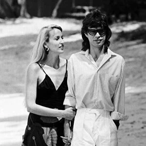 Jerry Hall arm with her boyfriend Rolling Stones; Mick Jagger in Barbados March 1987