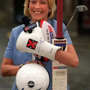 Jill Douglas TV Presenter 1999 who has joined Sky TV holding bat ball golf club