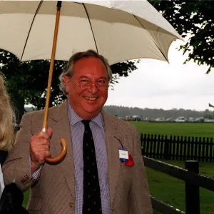 Jilly Cooper writer and husband Leo Cooper arrive in the rain for the Alfred Dunhill