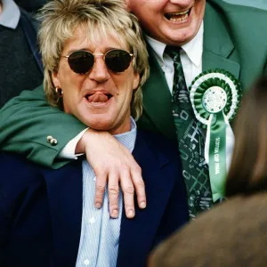 Jimmy Johnstone footballer with arm around singer Rod Stewart smiling tongue