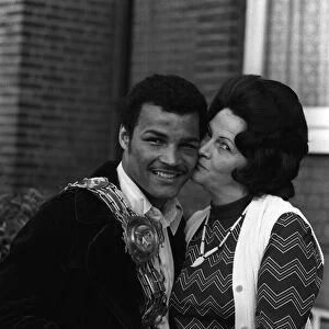 John Conteh gets a kiss from his mother after winning the British