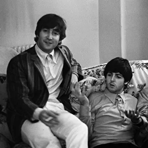 John Lennon, Paul McCartney and Ringo Starr of The Beatles relax in their room at