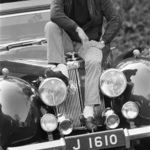 John Nettles, actor, pictured on the set of Bergerac. He is sitting on the car his