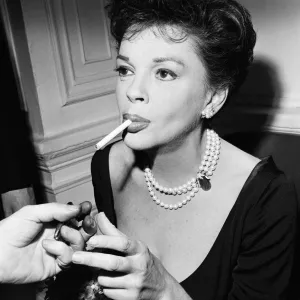 Judy Garland lighting a cigarette. 1963