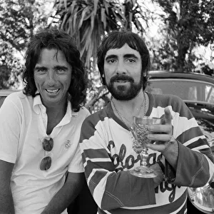 Keith Moon, drummer of The Who rock group and American rock star Alice Cooper pose with