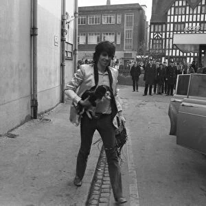 Keith richards arrives at Coventry Theatre carrying a young King Charles Spaniel under