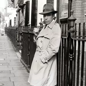 Kenny Whymark, Britains Look- a-like to the actor Humphrey Bogart, standing in the street