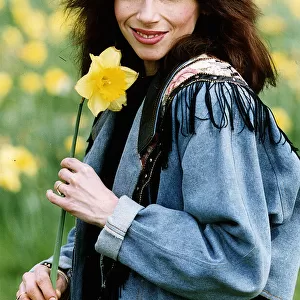 Lena Zavaroni singer with daffodil flower outisde her house in London. April 1993
