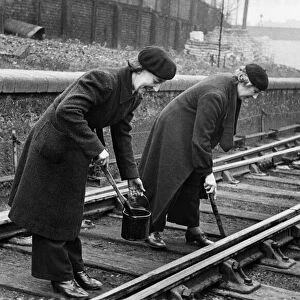 Lengthwomen at work oiling and scraping at Westbourne Park Railway Station, GWR