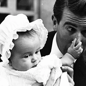 Leslie Crowther TV presenter with baby Charlotte Crowther at her christening in 1963