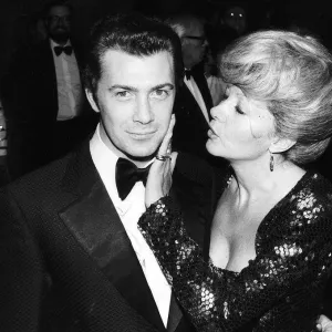 Lewis Collins Actor has his face caressed by Ingrid Pitt at the premiere of his film