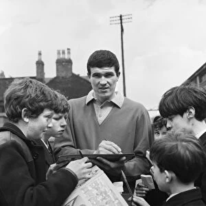 Liverpool footballer Ron Yeats signs autographs for young fans outside the Liverpool