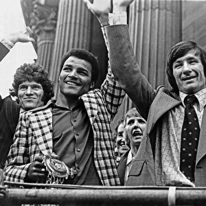 Liverpool footballer Tommy Smith holds the UEFA Cup trophy on an open top bus parade