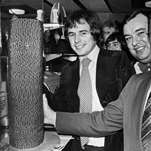 Liverpool manager Bob Paisley helps Nick Owen of BBC radio Birmingham transfer a pile of