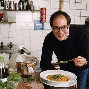 Loyd Grossman TV Presenter of Master Chef in his wn kitchen trying out his own cooking