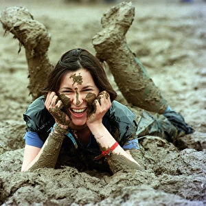 Lucy Rock enjoying the mud at Glastonbury festival June 1997