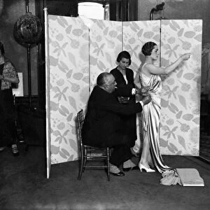 M. Paul Poiret designing a gown on one of his mannequins. December 1924 P008637