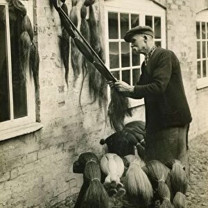 A man measuring lengths of horse hair for use in the weaving industry August 1930