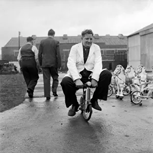 Man testing childrens toys bicycles and rocking horses. December 1953 D7321