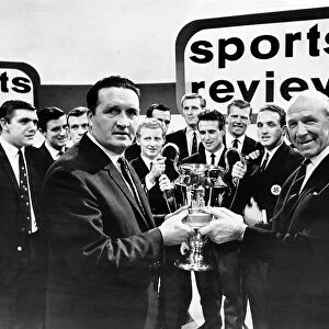 Manchester United football manager Matt Busby handing the Team of the Year Trophy to