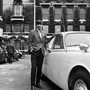 Manchester United footballer George Best beside his car. October 1967
