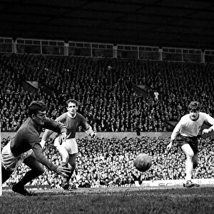 Manchester United goalkeeper Alec Stepney flings himself at the ball to save a fierce