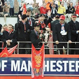 Manchester United Homecoming on open-top bus May 1999 is mobbed by fans at