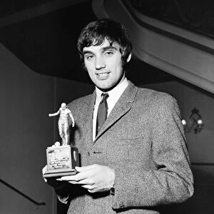 Manchester United star George Best holding his Footballer of the Year trophy