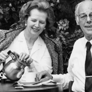 Margaret Thatcher and husband Denis drinking coffee in an outside cafe in a park - May