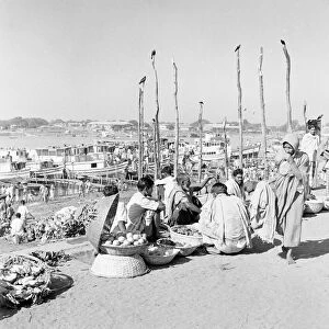 Market traders beside the harbour set up their stalls in Dacca, Bangladesh