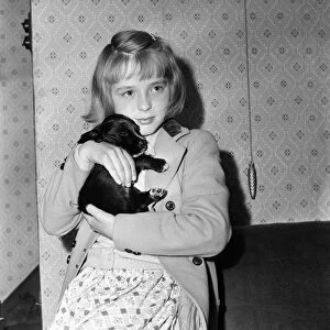 Mavis Ogden, aged 9 of Rochdale, with her new puppy - a gift from Mrs Chesworth of